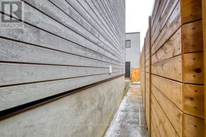 Toronto (Dovercourt-Wallace Emerson-Junction) apartment for rent - A narrow alley with wooden fences on both sides.