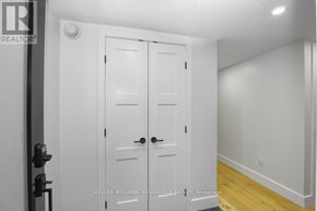 Toronto (Dovercourt-Wallace Emerson-Junction) apartment for rent - A white double door with a black handle is in a room with a white wall.