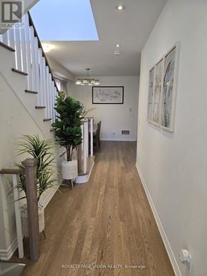 Whitby (Rolling Acres) apartment for rent - A long hallway with a skylight and a plant on the left.