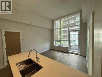 Vancouver apartment for rent - A kitchen with a sink and a window overlooking a building.