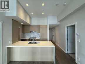 Vancouver apartment for rent - A modern kitchen with a large island and a sink.