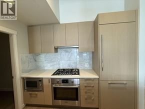 Vancouver apartment for rent - A kitchen with a marble countertop and stainless steel appliances.