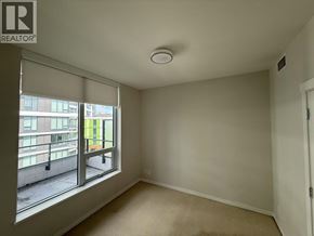 Vancouver apartment for rent - A room with a window overlooking a balcony.