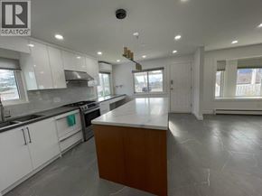Vancouver apartment for rent - A modern kitchen with white cabinets and a central island.