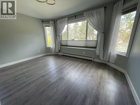 Vancouver apartment for rent - A room with a large window and curtains.
