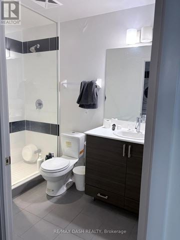 Toronto (Willowdale West) condo for rent - A bathroom with a toilet, sink, and mirror.