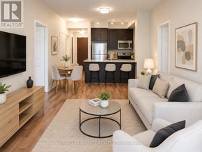 Mississauga (City Centre) condo for rent - A living room with a white couch, a coffee table, and a television.