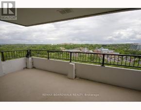 Ottawa house for rent - A balcony with a black railing and a person standing on it.