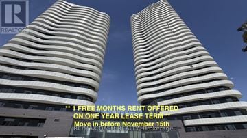 Vaughan (Steeles West Industrial) condo for rent - Two tall buildings with a sign offering a free month's rent on a one year lease term.