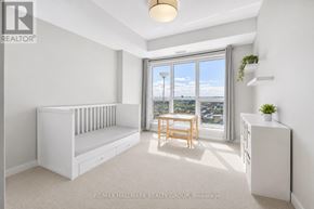 Ottawa condo for rent - A white bedroom with a window seat and a wooden table.