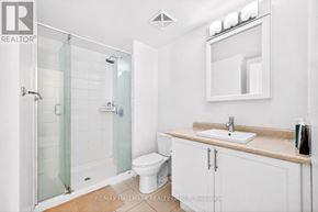 Ottawa condo for rent - A white bathroom with a glass shower stall and a toilet.