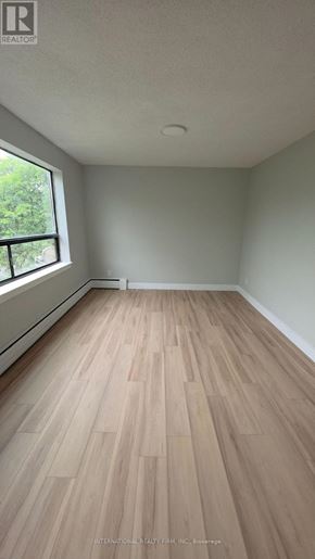 Hamilton (Mcquesten) multi-family for rent - A room with wooden flooring and a window.