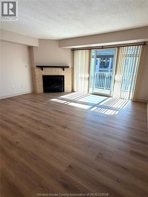 Lasalle condo for rent - A living room with a fireplace and sliding glass doors.
