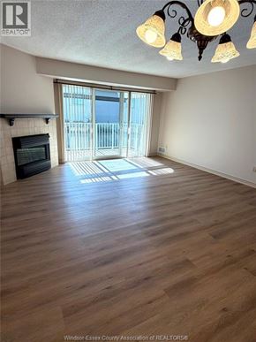 Lasalle condo for rent - A room with wooden flooring and a chandelier.