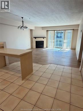 Lasalle condo for rent - A spacious living room with a fireplace and sliding glass doors.