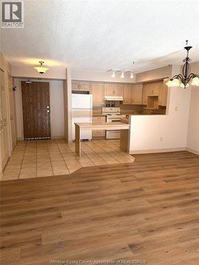 Lasalle condo for rent - A kitchen with wooden floors and a dining table.