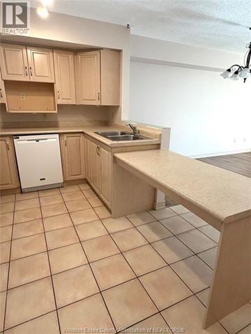 Lasalle condo for rent - A kitchen with wooden cabinets and a dishwasher.