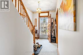 Guelph (Junction/Onward Willow) apartment for rent - A hallway with a chandelier, a painting, and a coat rack.