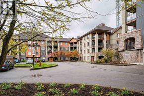 New Westminster apartment for rent - A large building with a courtyard in front of it.