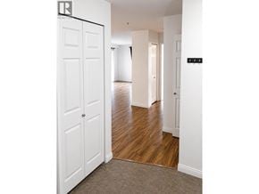 New Westminster apartment for rent - A hallway with white doors and a black sign on the wall.