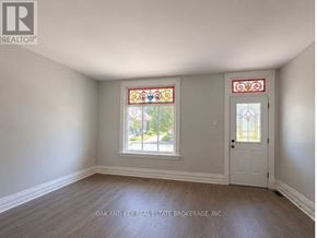 London East (East G) multi-family for rent - A room with a white door and a window with a stained glass design.