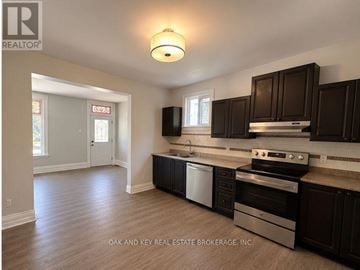 London East (East G) multi-family for rent - A kitchen with dark brown cabinets and stainless steel appliances.