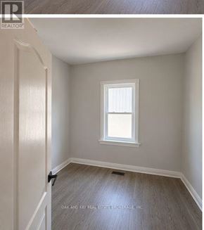 London East (East G) multi-family for rent - A room with a window and wooden flooring.