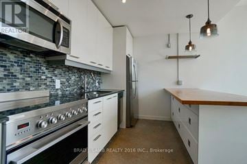 Toronto (Moss Park) condo for rent - A kitchen with a stove top oven and microwave above it.