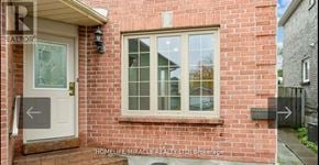 Ajax (Central West) apartment for rent - A red brick house with a white door and a window.