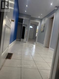 Toronto (Dovercourt-Wallace Emerson-Junction) apartment for rent - A hallway with a tiled floor and a blue wall on the left.