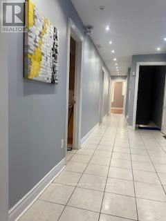 Toronto (Dovercourt-Wallace Emerson-Junction) apartment for rent - A hallway with a painting on the wall and a door at the end.