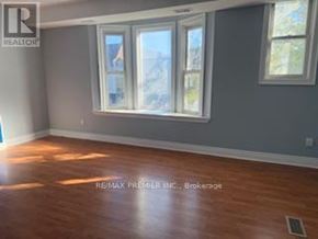 Toronto (Dovercourt-Wallace Emerson-Junction) apartment for rent - A room with a large window and wooden flooring.