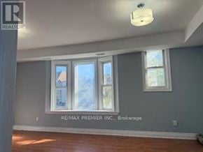 Toronto (Dovercourt-Wallace Emerson-Junction) apartment for rent - A room with a window and a sign that says RE/MAX Premier Inc. Brokerage.