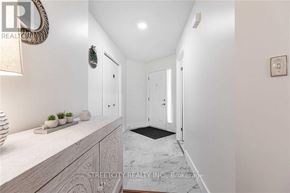 London North (North C) apartment for rent - A hallway with a marble floor and white walls.