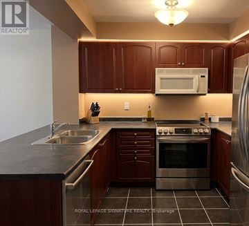 Richmond Hill (Langstaff) condo for rent - A kitchen with brown cabinets and a stainless steel oven.