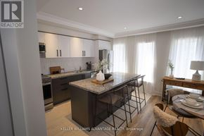 Toronto (Rockcliffe-Smythe) multi-family for rent - A modern kitchen with a granite countertop and stainless steel appliances.