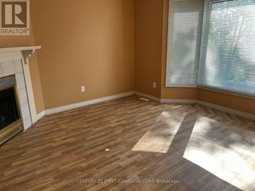 London North (North G) townhouse for rent - A room with a fireplace and wooden flooring.