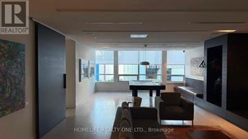Toronto (Regent Park) condo for rent - A modern living room with a dining table and chairs is showcased.