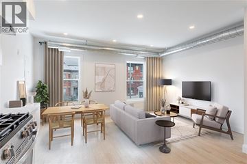Hamilton apartment for rent - A modern living room with a dining table and a sofa.