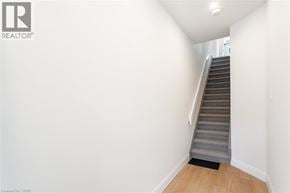 Hamilton apartment for rent - A staircase with a carpeted step leading up to a light on the ceiling.