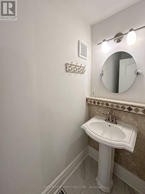 Toronto (Willowdale East) apartment for rent - A white pedestal sink in a bathroom with a mirror and lights above it.