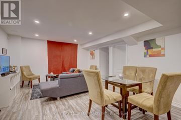 Brampton (Credit Valley) apartment for rent - A living room with a grey couch, a glass table and a TV.