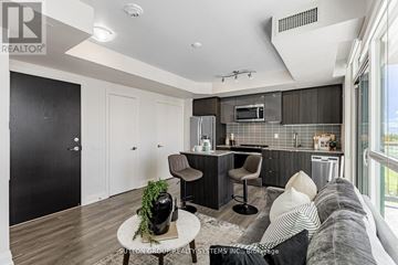 Toronto (Brookhaven-Amesbury) condo for rent - A modern kitchen with a breakfast bar and a living room area with a couch and a coffee table.