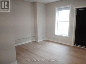 Peterborough (Town Ward 3) condo for rent - A room with a window and wooden flooring.