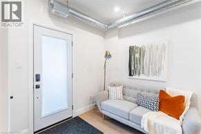 Hamilton apartment for rent - A living room with a grey couch and a painting on the wall.
