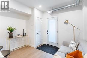 Hamilton apartment for rent - A living room with a grey couch and a black and white throw pillow.