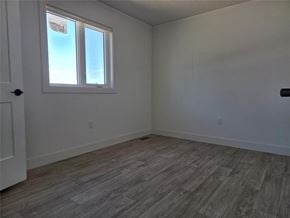 Mitchell apartment for rent - A room with a window and wooden flooring.