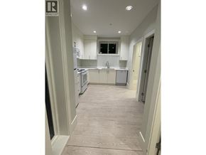 Vancouver apartment for rent - A kitchen with white cabinets and a window.