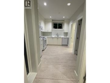 Vancouver apartment for rent - A kitchen with white cabinets and a window.