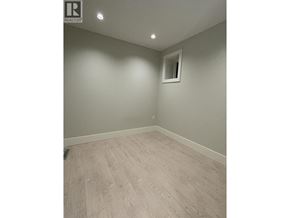 Vancouver apartment for rent - A room with a wooden floor and a small window.